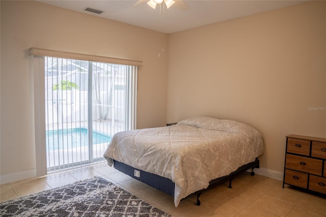 bedroom with baseboards, light tile patterned floors, visible vents, and access to exterior