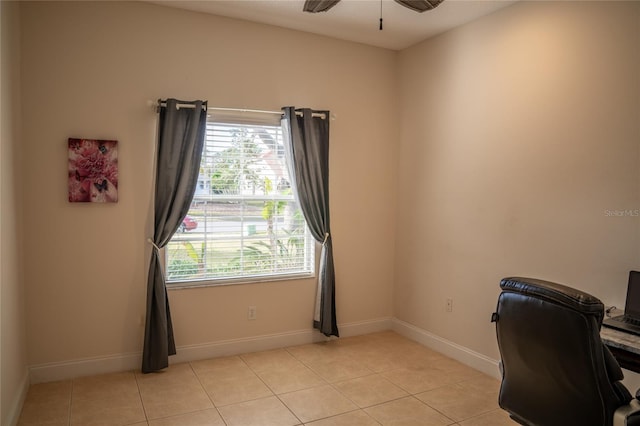 home office with a healthy amount of sunlight, light tile patterned floors, baseboards, and a ceiling fan