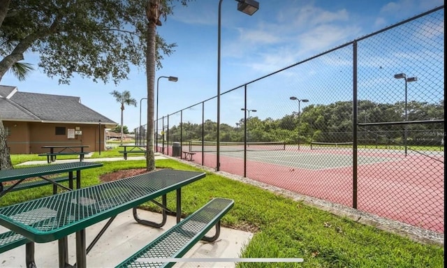 view of tennis court featuring fence