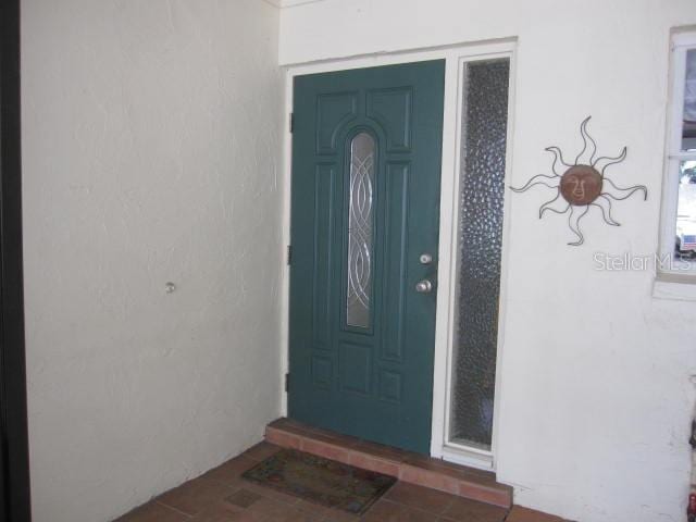 property entrance with stucco siding