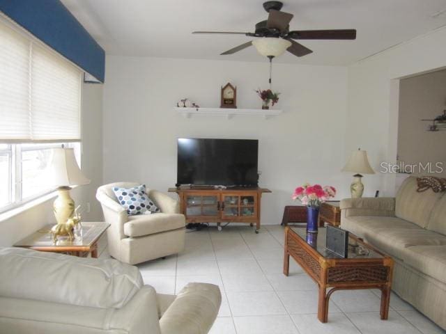 living room with light tile patterned flooring and ceiling fan