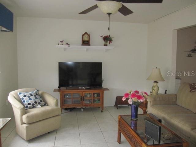 living room featuring ceiling fan and light tile patterned floors