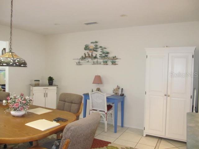 dining area with light tile patterned flooring