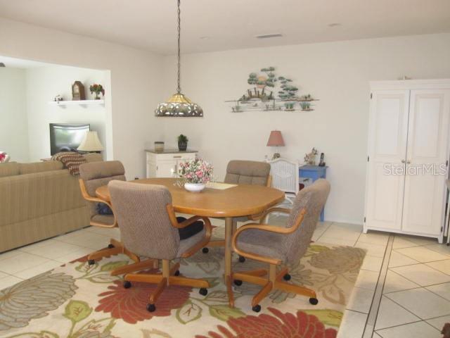 dining area featuring light tile patterned flooring