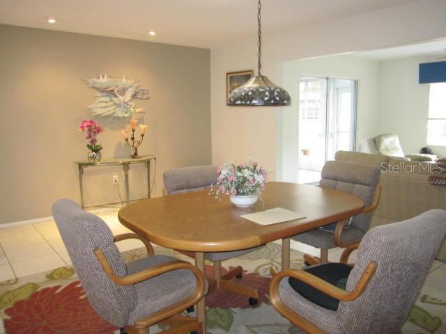 dining area with baseboards and light tile patterned floors