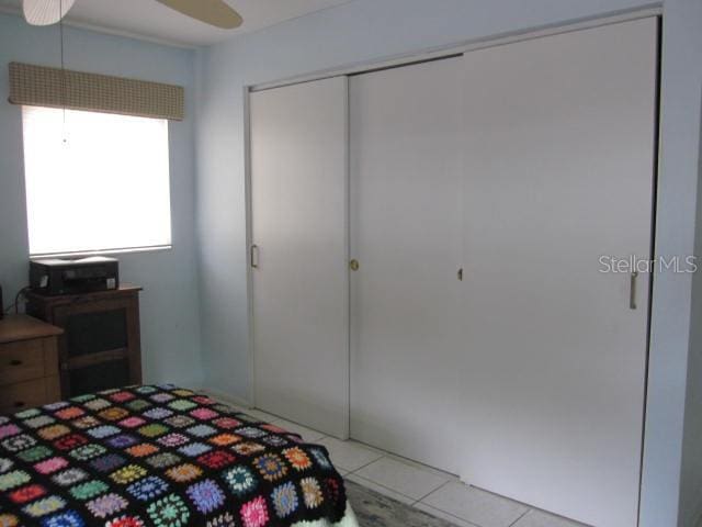 tiled bedroom featuring a closet