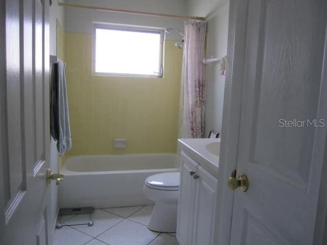 bathroom with shower / tub combination, vanity, toilet, and tile patterned floors