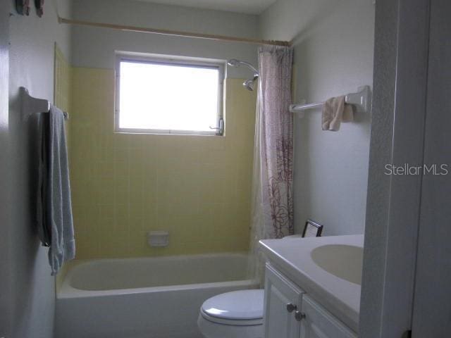 full bathroom with toilet, vanity, and bathing tub / shower combination