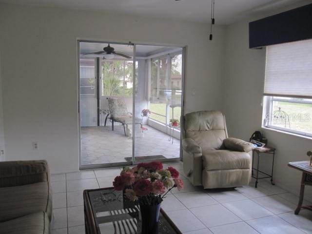 living room featuring light tile patterned flooring and ceiling fan