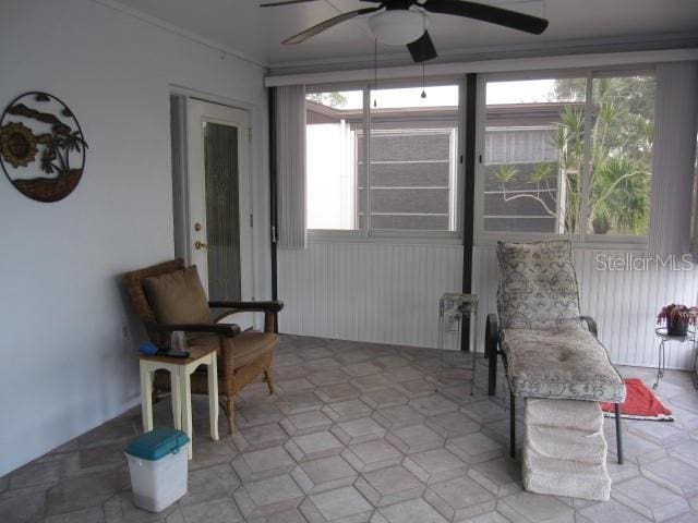 sunroom with a wealth of natural light and a ceiling fan