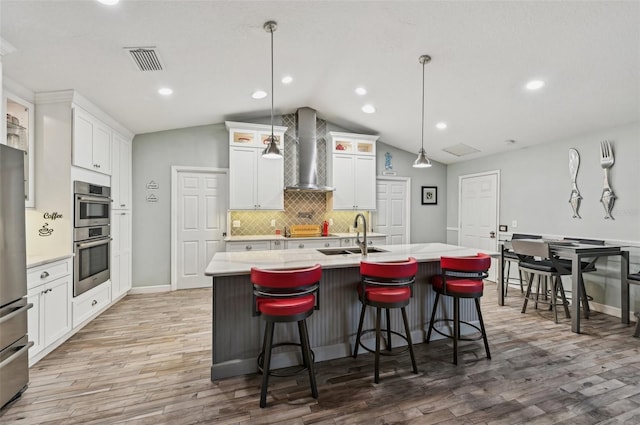 7415 36th Ave E, Palmetto, FL 34221 - kitchen with an island with sink, wall chimney exhaust hood, decorative light fixtures, and sink