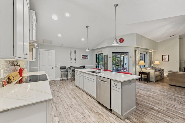 7415 36th Ave E, Palmetto, FL 34221 - kitchen with dishwasher, white cabinetry, sink, hanging light fixtures, and a kitchen island with sink