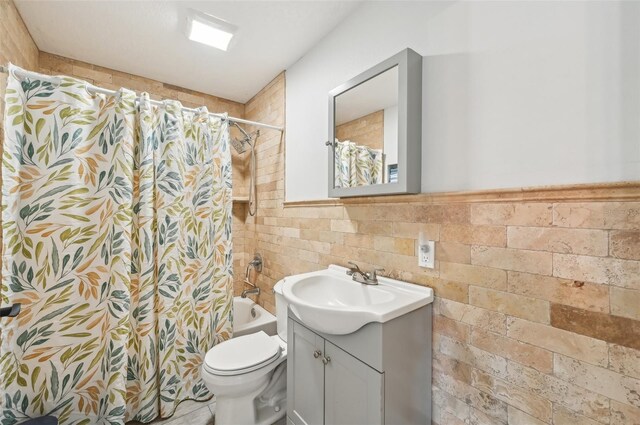 7415 36th Ave E, Palmetto, FL 34221 - full bathroom with vanity, tile walls, shower / bath combo with shower curtain, and toilet