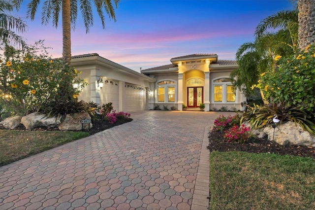 mediterranean / spanish-style home with french doors and a garage