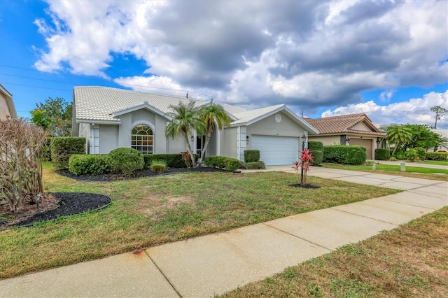 view of front of property featuring a garage and a front lawn