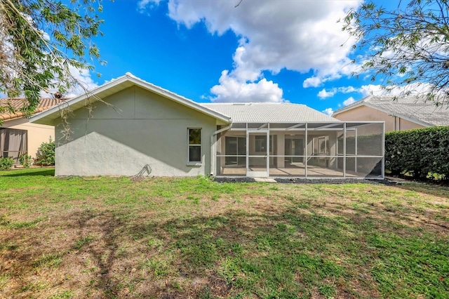 back of property featuring a patio area and a lawn