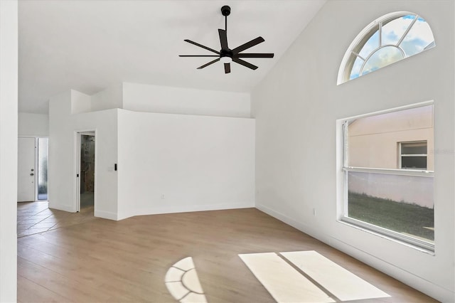 spare room featuring ceiling fan, high vaulted ceiling, and light wood-type flooring