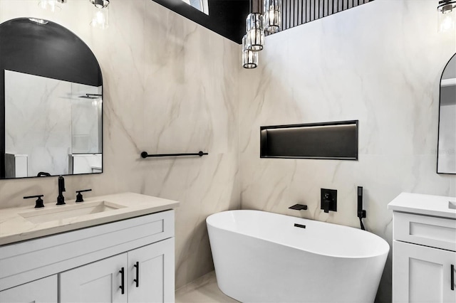 bathroom featuring vanity and a tub