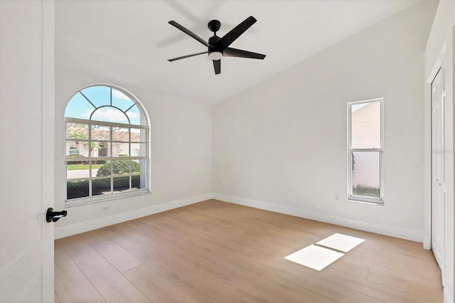 spare room featuring vaulted ceiling, ceiling fan, and light wood-type flooring