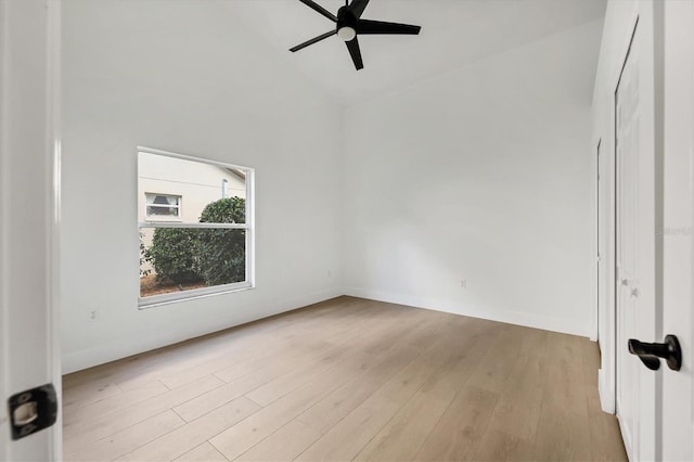 spare room featuring high vaulted ceiling, ceiling fan, and light wood-type flooring