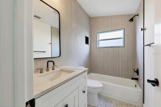 full bathroom with tiled shower / bath, vanity, and toilet