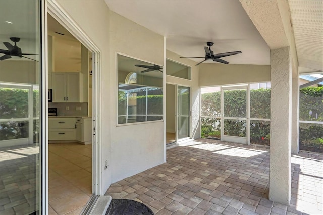 unfurnished sunroom with plenty of natural light, ceiling fan, and vaulted ceiling