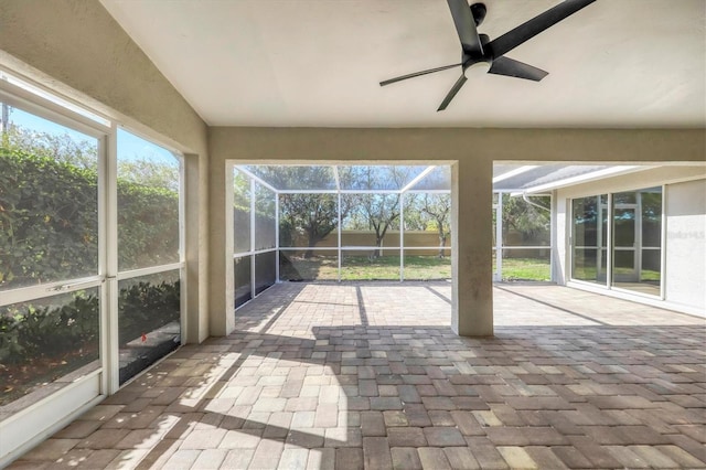 unfurnished sunroom featuring ceiling fan