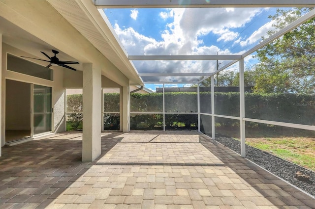 unfurnished sunroom with ceiling fan