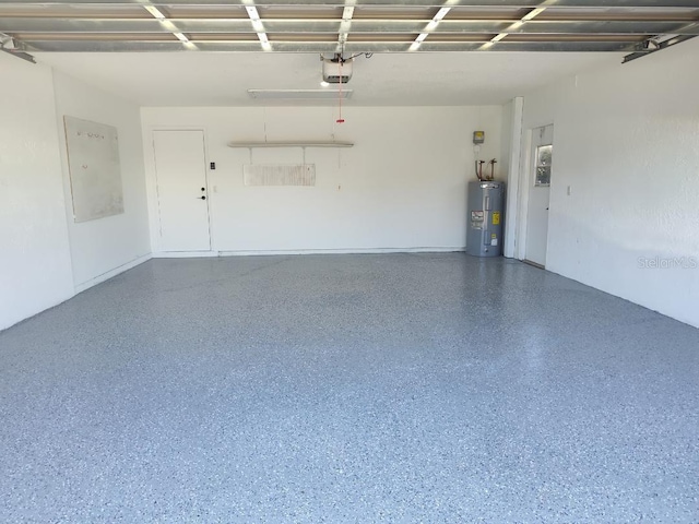 garage featuring a garage door opener and electric water heater