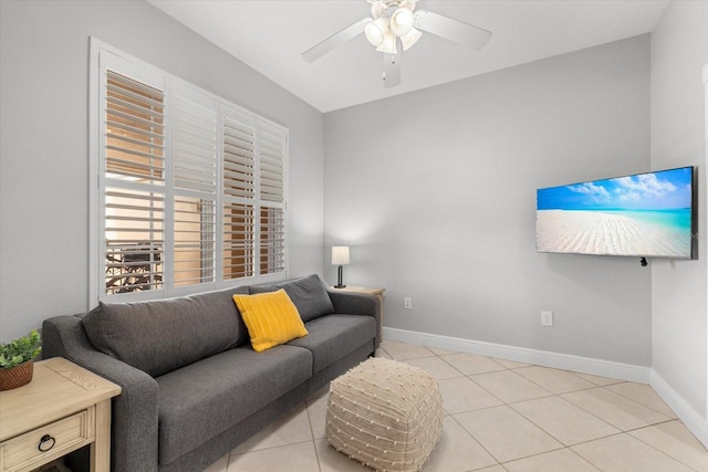 living room with a ceiling fan, baseboards, and light tile patterned floors