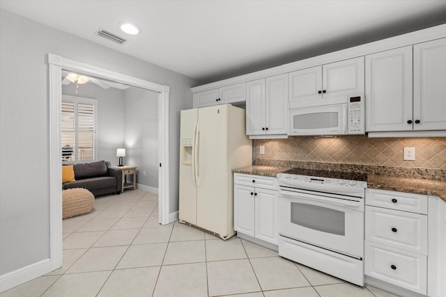kitchen featuring light tile patterned floors, white appliances, visible vents, and white cabinets