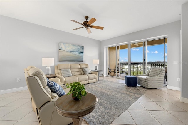 living room with ceiling fan, baseboards, and light tile patterned floors