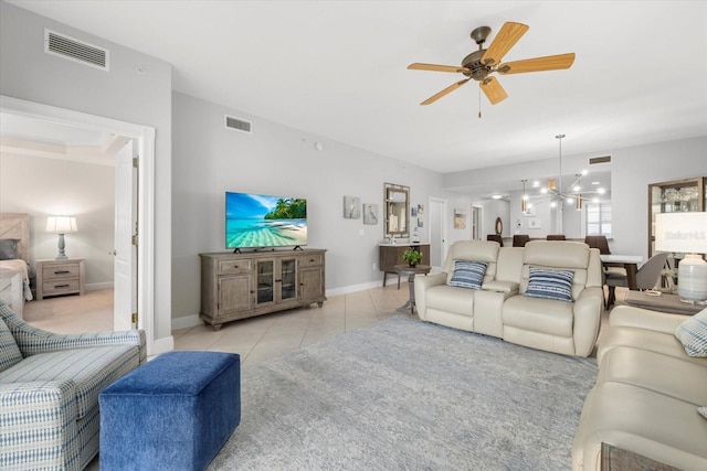 living room with ceiling fan with notable chandelier, light tile patterned flooring, and visible vents