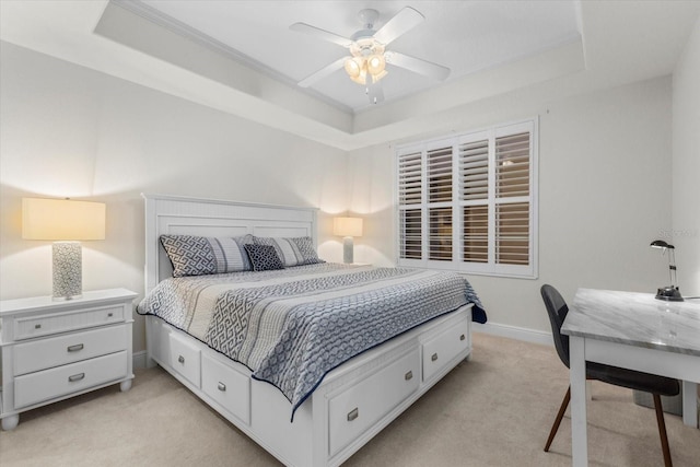 bedroom with light carpet, ceiling fan, baseboards, and a raised ceiling