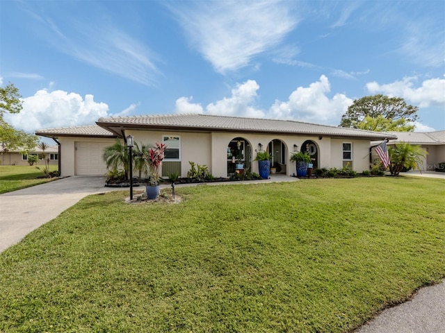 view of front facade with a garage and a front lawn