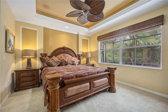 bedroom featuring a ceiling fan, a raised ceiling, crown molding, and baseboards