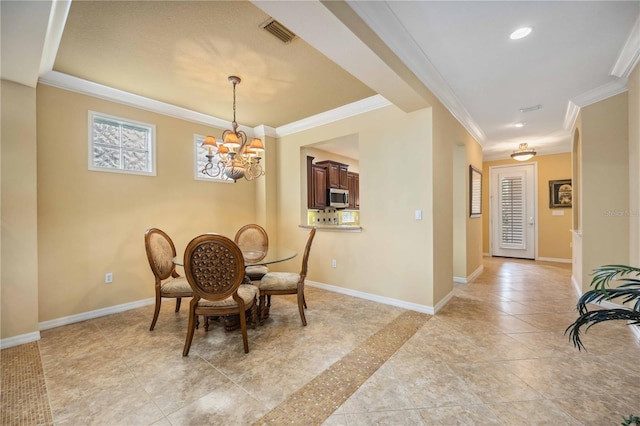 dining area featuring crown molding, light tile patterned floors, visible vents, a chandelier, and baseboards