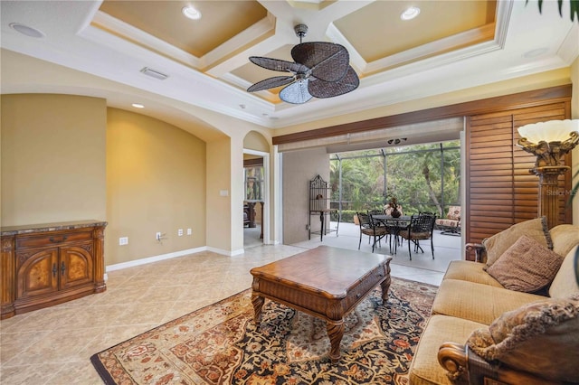 living area featuring baseboards, visible vents, coffered ceiling, and ornamental molding