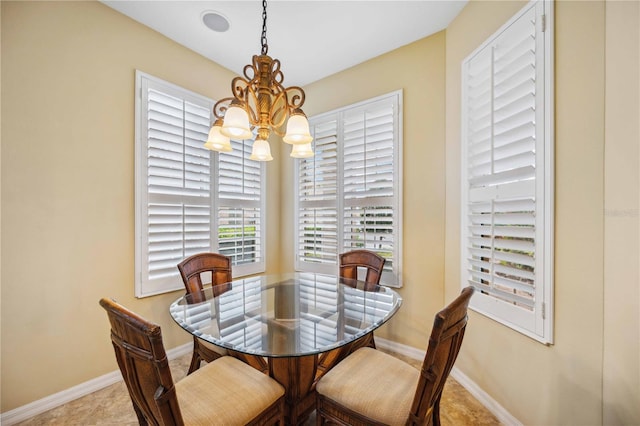 dining area with baseboards and a chandelier