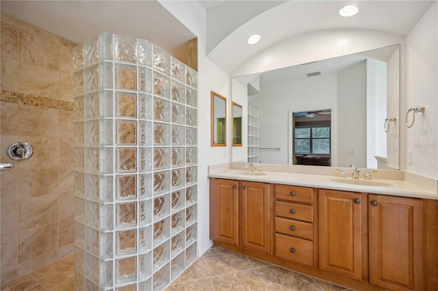 full bath with a walk in shower, double vanity, and a sink