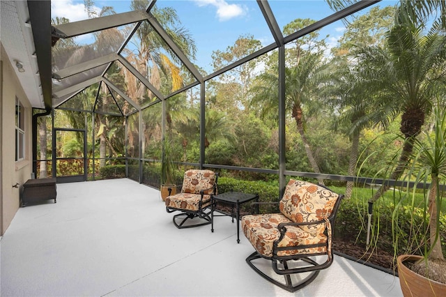 view of patio with glass enclosure