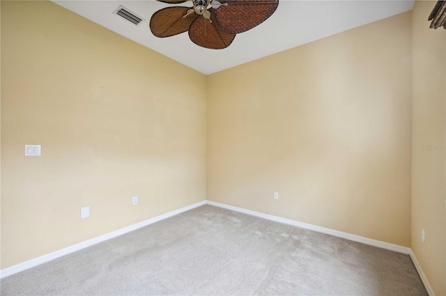 unfurnished room featuring carpet floors, visible vents, baseboards, and a ceiling fan