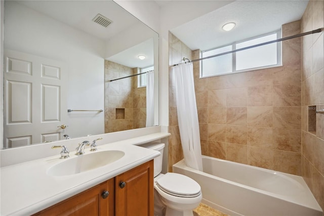 bathroom featuring visible vents, shower / tub combo with curtain, vanity, and toilet