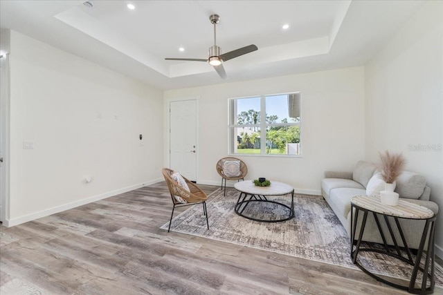 18290 Grace Ave, Port Charlotte, FL 33948 - sitting room featuring a tray ceiling, a ceiling fan, wood finished floors, and recessed lighting