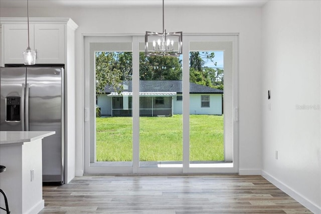 18290 Grace Ave, Port Charlotte, FL 33948 - unfurnished dining area with a chandelier and light wood-type flooring