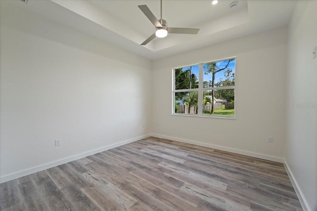 18290 Grace Ave, Port Charlotte, FL 33948 - unfurnished room with a raised ceiling, wood finished floors, and a ceiling fan