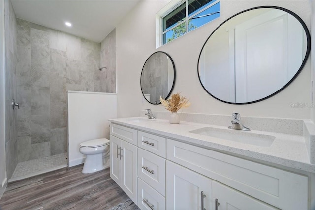 18290 Grace Ave, Port Charlotte, FL 33948 - bathroom featuring double vanity, a walk in shower, wood finished floors, and recessed lighting