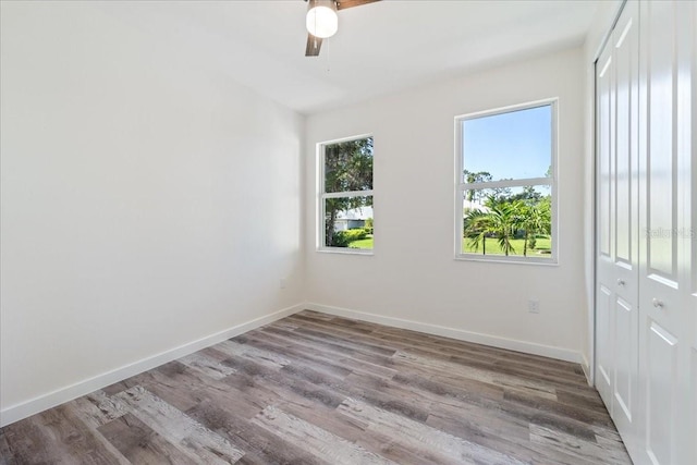 18290 Grace Ave, Port Charlotte, FL 33948 - unfurnished bedroom with a closet, wood finished floors, and ceiling fan