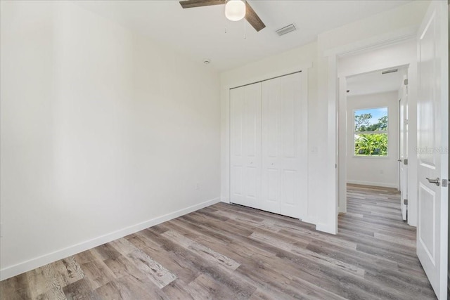 18290 Grace Ave, Port Charlotte, FL 33948 - unfurnished bedroom with a closet, wood finished floors, and ceiling fan