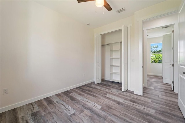 18290 Grace Ave, Port Charlotte, FL 33948 - unfurnished bedroom with wood finished floors, a ceiling fan, and a closet